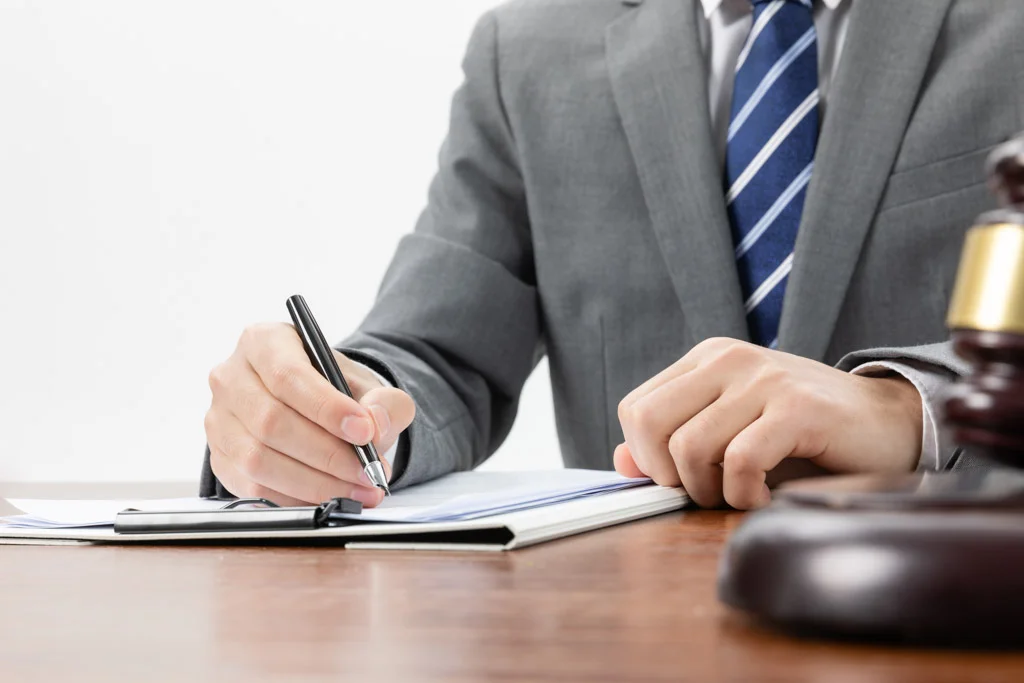 A closeup shot of a businessman signing some official papers