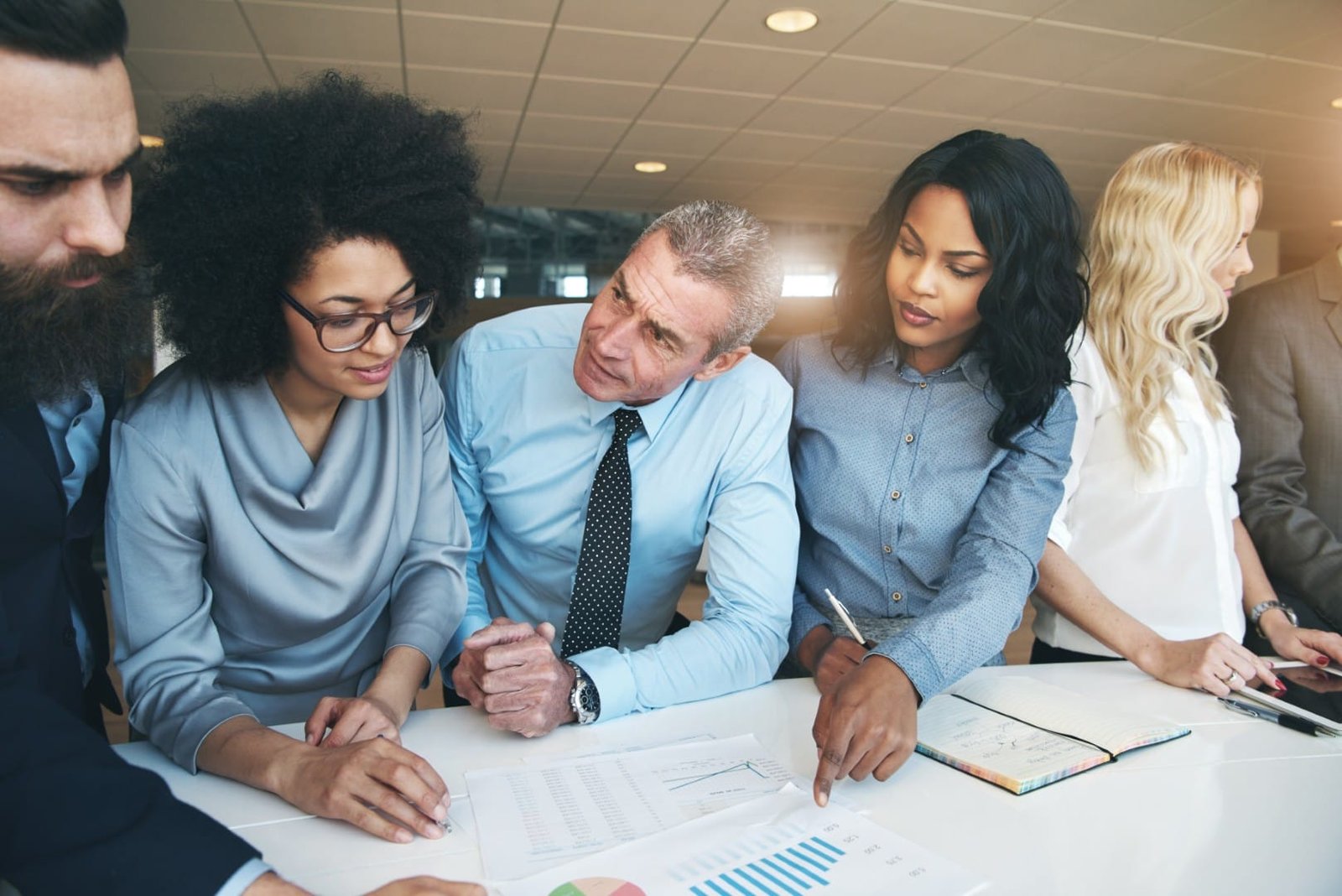 multiethnic-team-discussing-and-working-with-paper-2024-09-13-22-44-34-utc